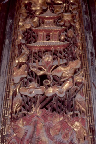 Elaborate wood carvings decorate doors of temples and traditional houses.