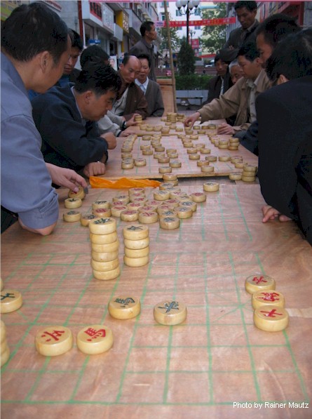 Playing Chinese Chess, a favorite game everywhere in China
