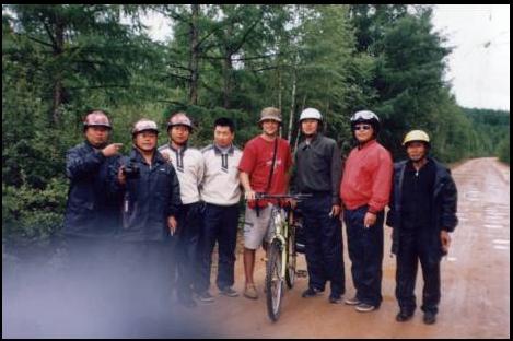 Muddy mountain road to Mohe on Bike China tour